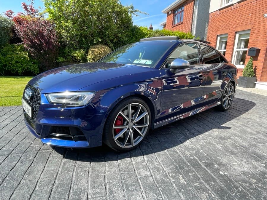 Front three-quarter view of a blue Audi S3 on a driveway